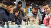 Russell Makofsky founder of The Gift of Chess with young chess students